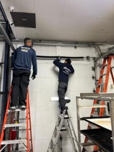Fairway Garage Door technicians installing a commercial overhead loading dock door in Chicago