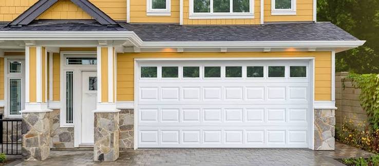 White garage door on yellow house